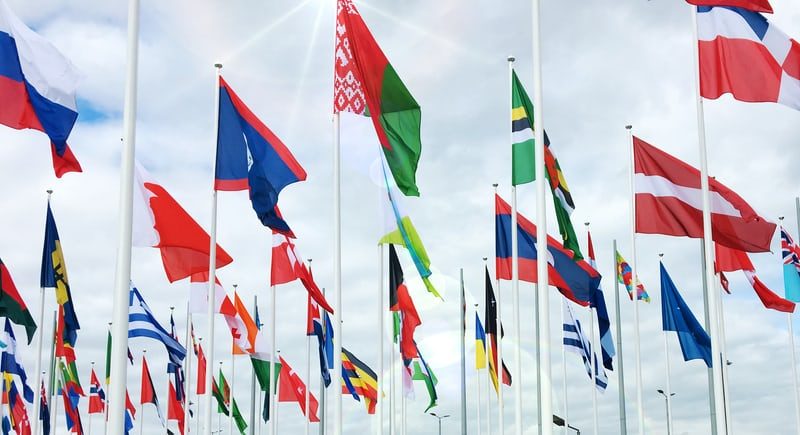 A bunch of flags are flying in the air